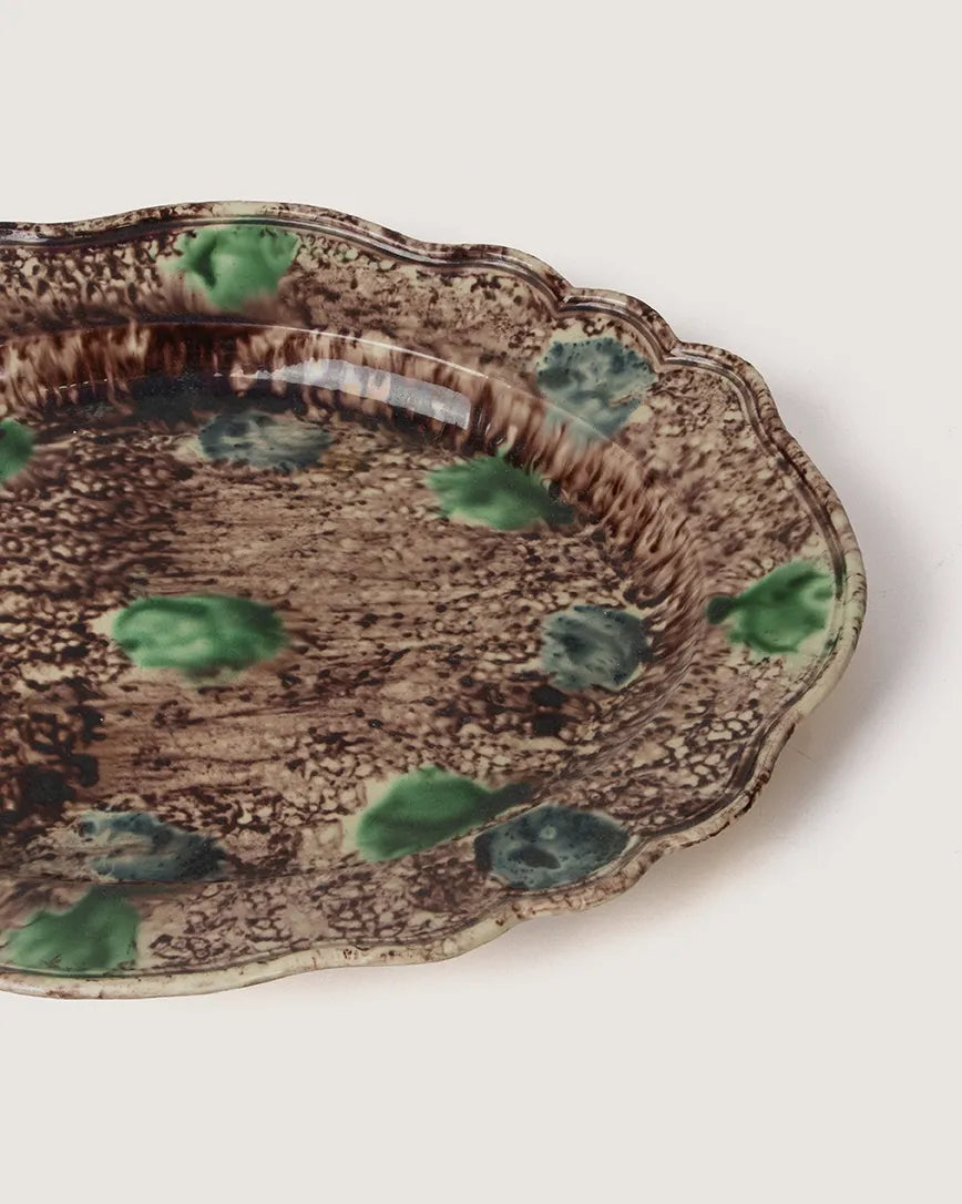 close-up of vibrant colored
glazes and intricate molded
detail on antique majolica