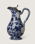 Beautiful late 19th-century antique relief-molded ceramic jug featuring a classic blue and white design and original pewter lid.