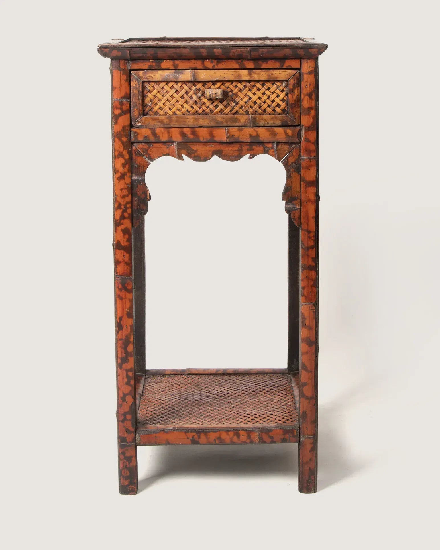 Late 19th-century antique colonial side table or nightstand crafted from rich organic tortoiseshell bamboo.