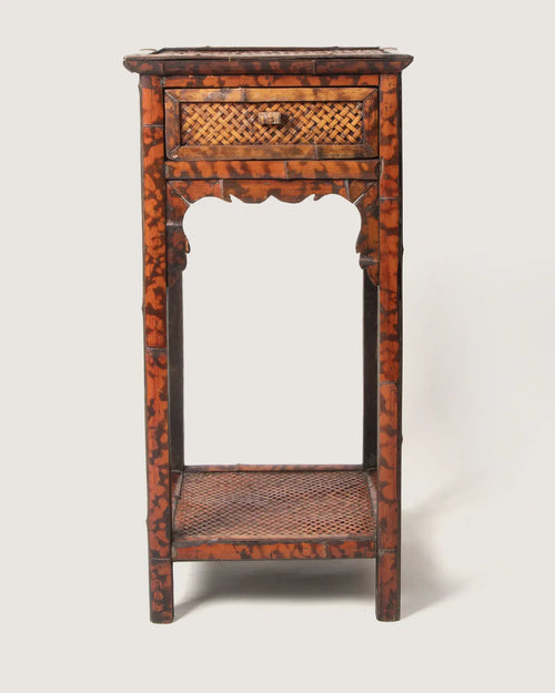 Late 19th-century antique colonial side table or nightstand crafted from rich organic tortoiseshell bamboo.
