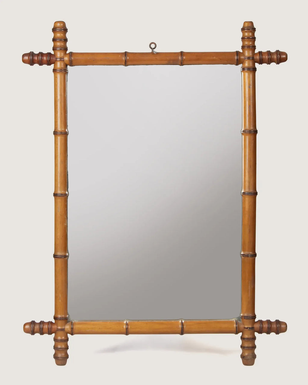 Full front independent view of the 60 x 78 cm antique French faux bamboo mirror with its original top hanging ring against a white backdrop.