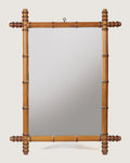 Full front independent view of the 60 x 78 cm antique French faux bamboo mirror with its original top hanging ring against a white backdrop.