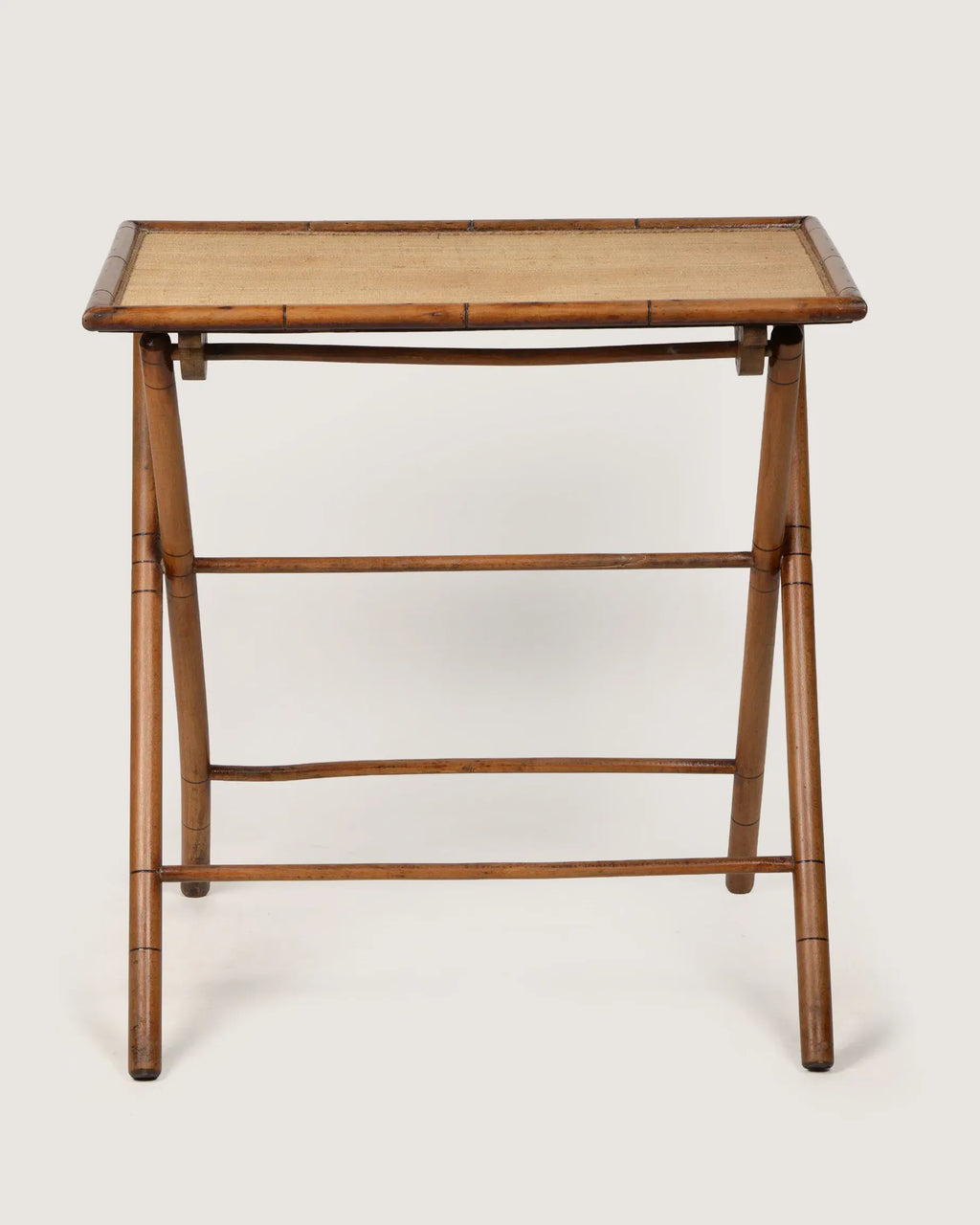 Early 20th-century antique French wooden side table with finely carved faux bamboo legs and trim.
