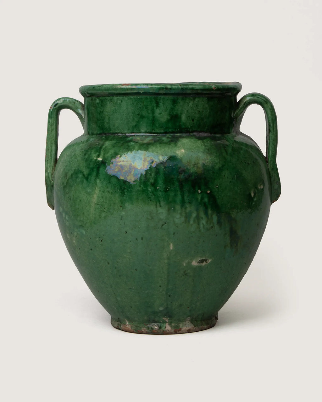 Vintage early 20th-century French terracotta confit pot coated in a vibrant, glossy green glaze.