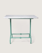 Antique late 19th-century outdoor bistro table featuring an ornate mint green cast iron base and a circular white marble top. One-of-a-kind vintage garden decor curated by Atelier Bellinzona.