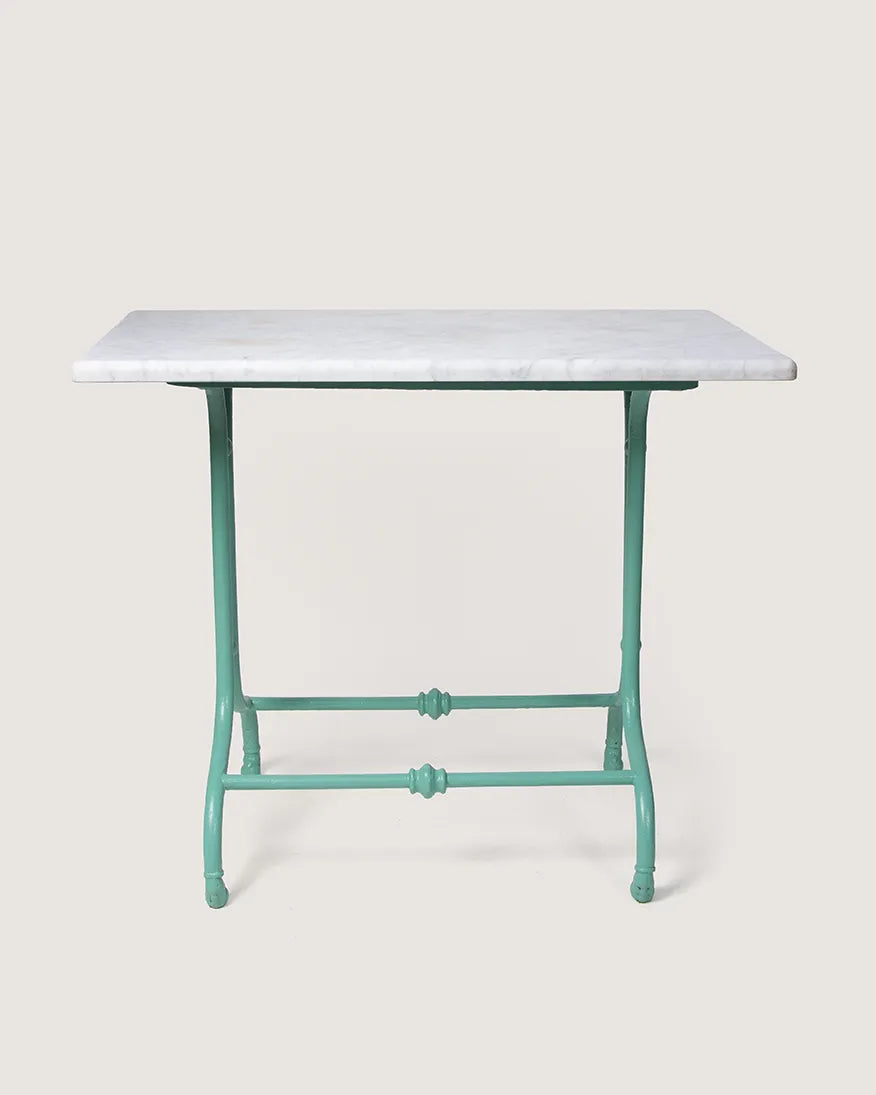 Antique late 19th-century outdoor bistro table featuring an ornate mint green cast iron base and a circular white marble top. One-of-a-kind vintage garden decor curated by Atelier Bellinzona.