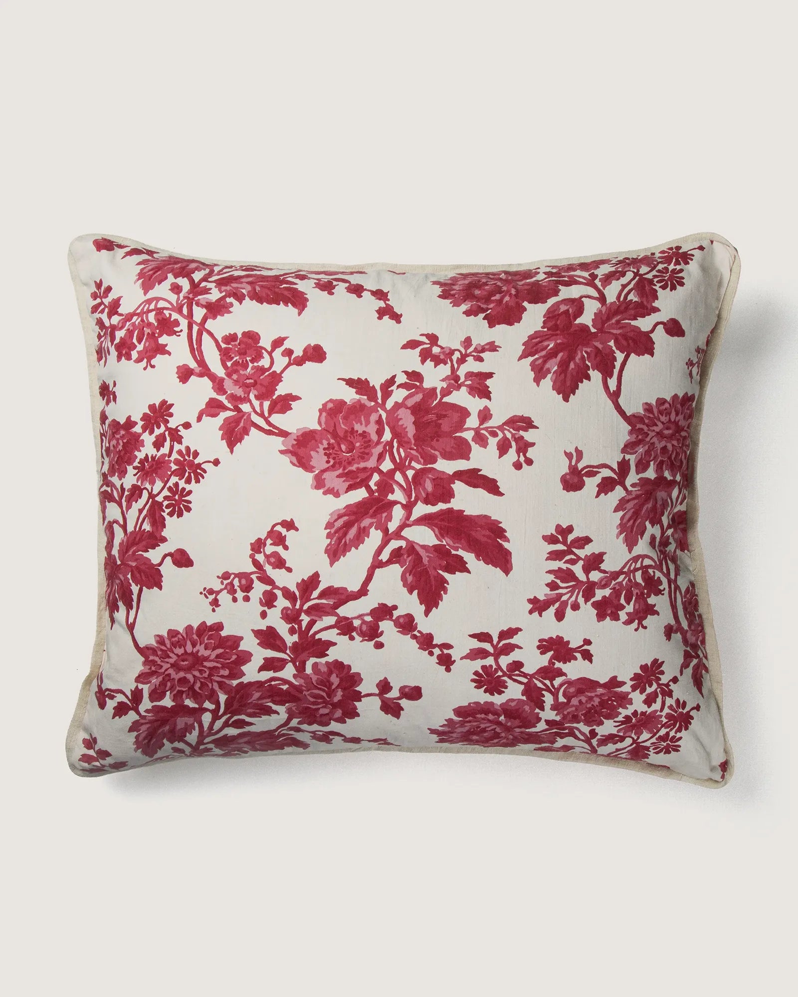 Full front view of a large 58x50 cm square cushion featuring a raspberry red monochrome botanical Toile de Jouy pattern on a cream background.