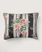 Full front view of a 52x42 cm rectangular cushion in vintage Sanderson cotton, showcasing large pink roses and purple lilacs printed over wide black and white vertical bands.