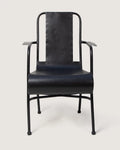 Vintage 1950s industrial medical chair in black enameled metal, expertly restored and repurposed for eclectic outdoor seating. One-of-a-kind vintage design curated by Atelier Bellinzona.