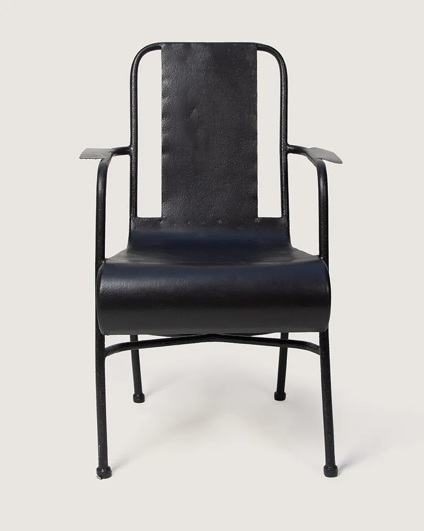 Vintage 1950s industrial medical chair in black enameled metal, expertly restored and repurposed for eclectic outdoor seating. One-of-a-kind vintage design curated by Atelier Bellinzona.