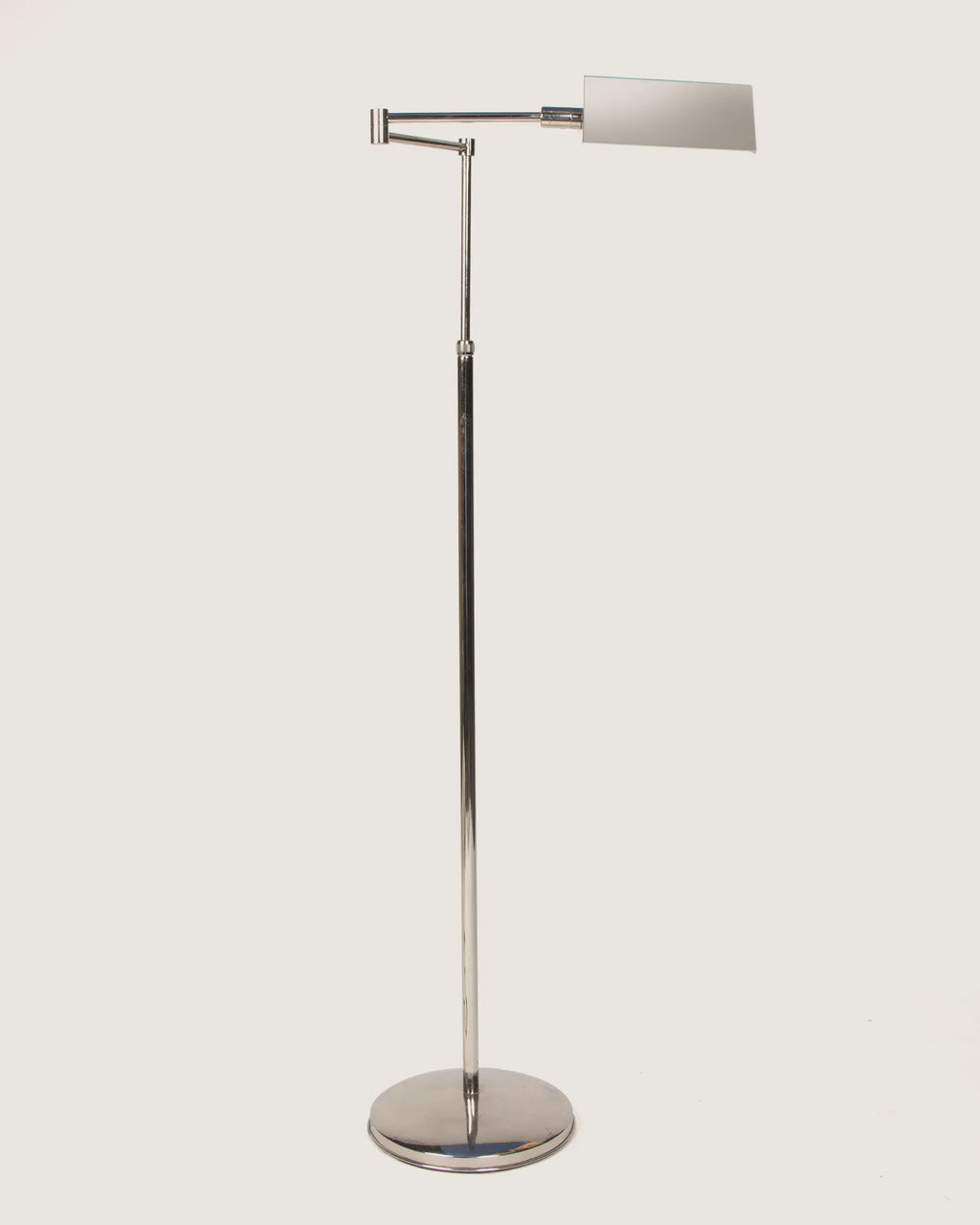 Italian mid-century modern adjustable pharmacy style floor lamp in sleek, polished chrome with a minimalist design. One-of-a-kind vintage lighting curated by Atelier Bellinzona.