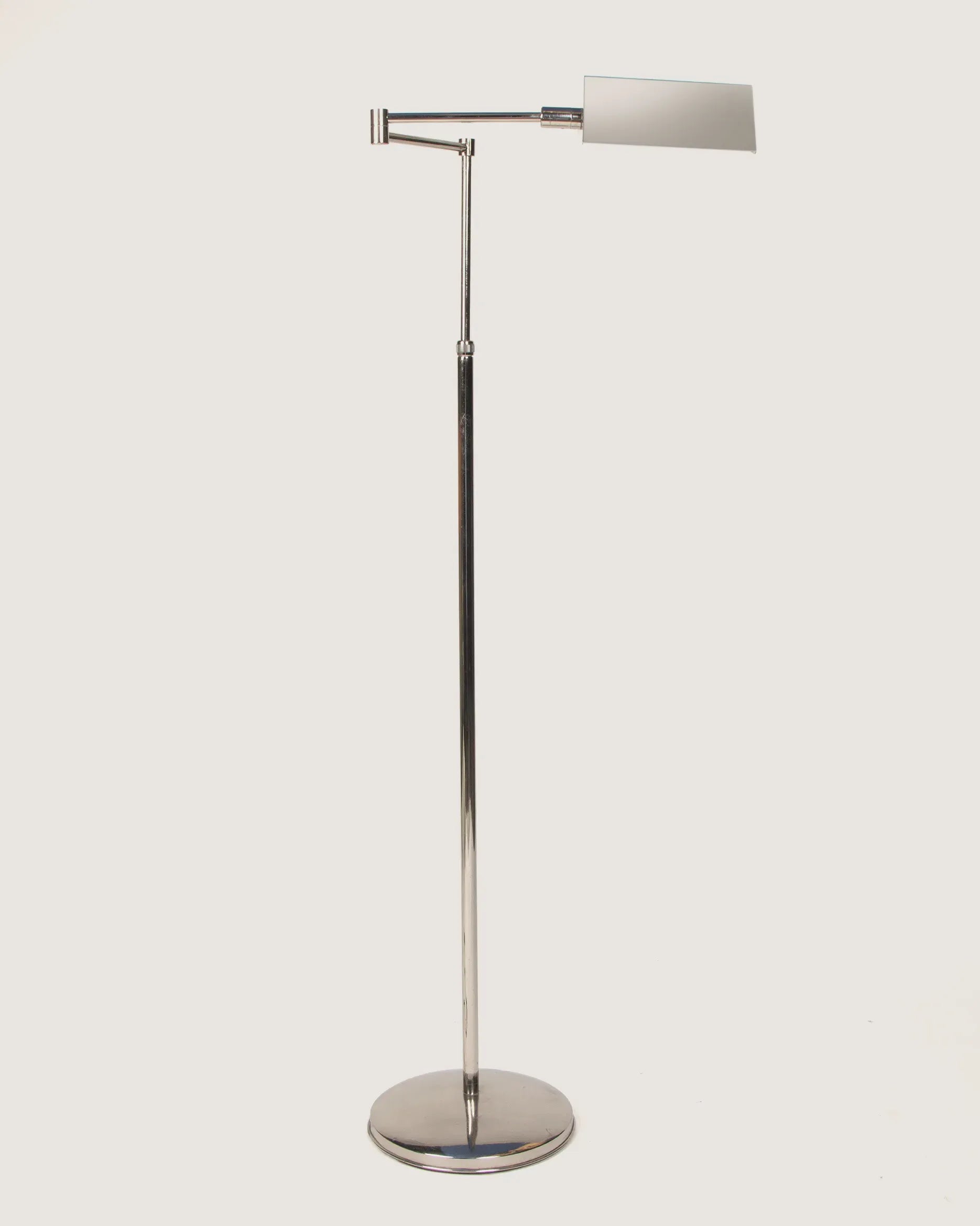 Italian mid-century modern adjustable pharmacy style floor lamp in sleek, polished chrome with a minimalist design. One-of-a-kind vintage lighting curated by Atelier Bellinzona.