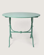 Mid-century 1950s Italian round folding garden bistro table in a striking mint green lacquered iron finish. One-of-a-kind vintage garden decor curated by Atelier Bellinzona.