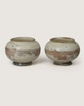 Pair of early 1900s antique terracotta cachepots from Central Italy with a beautifully distressed white glazed patina.