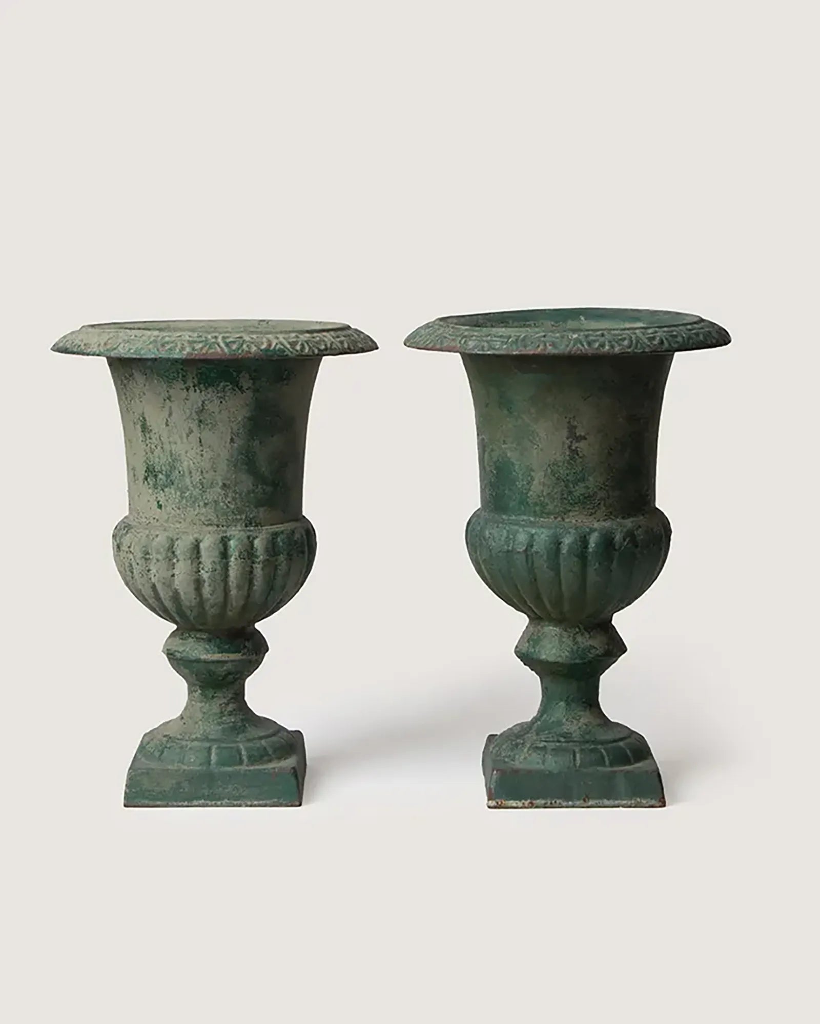 Pair of late 19th-century antique French cast iron Medici urns showing a stunning verdigris weathered patina.