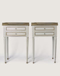 Full front studio view of the matching pair of Louis XVI style lacquered bedside tables standing symmetrically side by side.