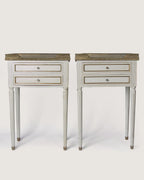 Full front studio view of the matching pair of Louis XVI style lacquered bedside tables standing symmetrically side by side.