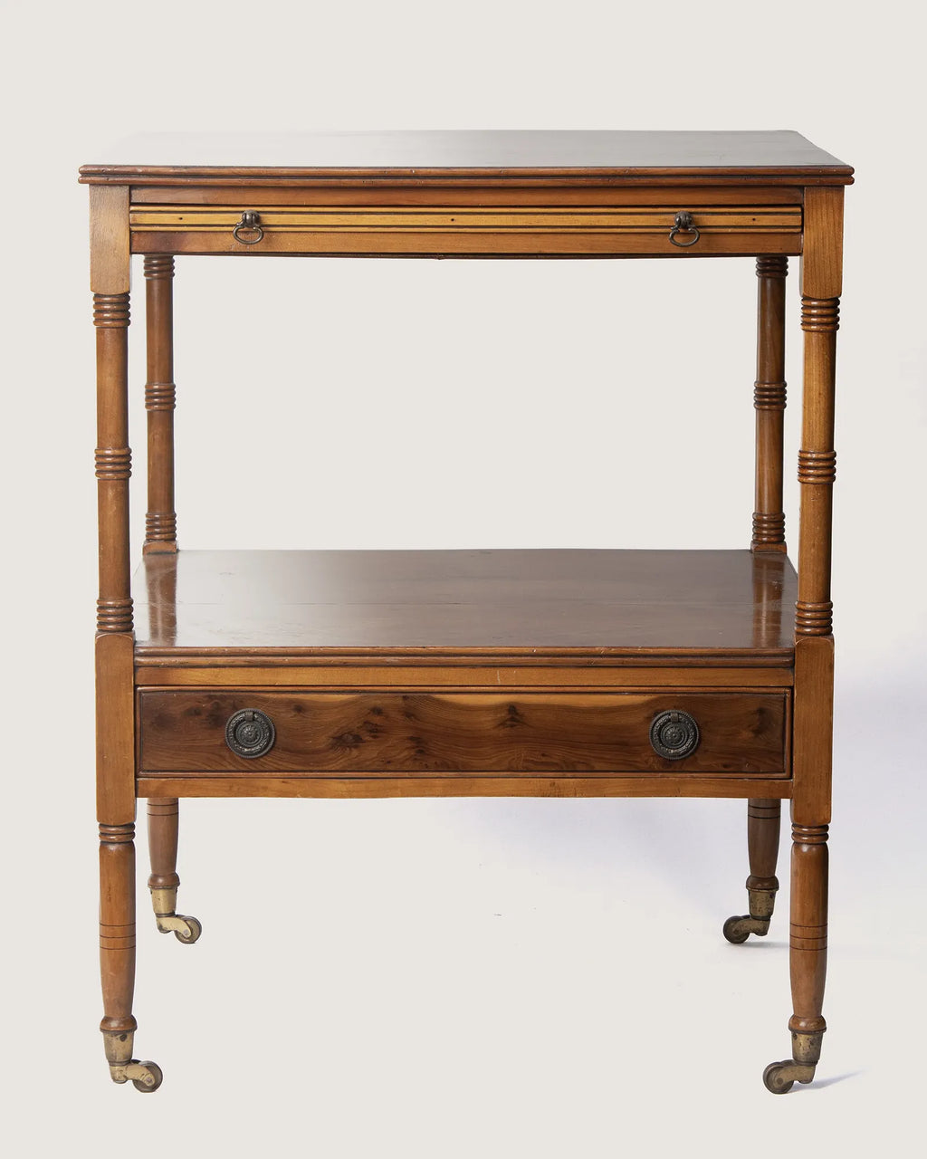 Full front studio view of the matching pair of antique French walnut side tables standing symmetrically side by side.