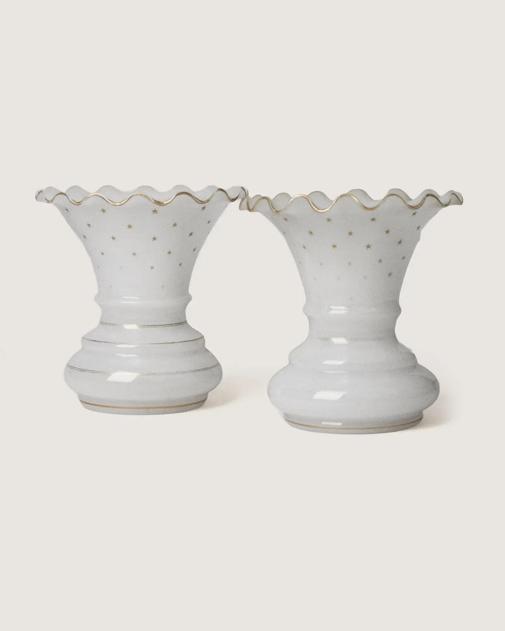 Stunning pair of late 19th-century French white opaline glass vases adorned with delicate gilded gold stars.