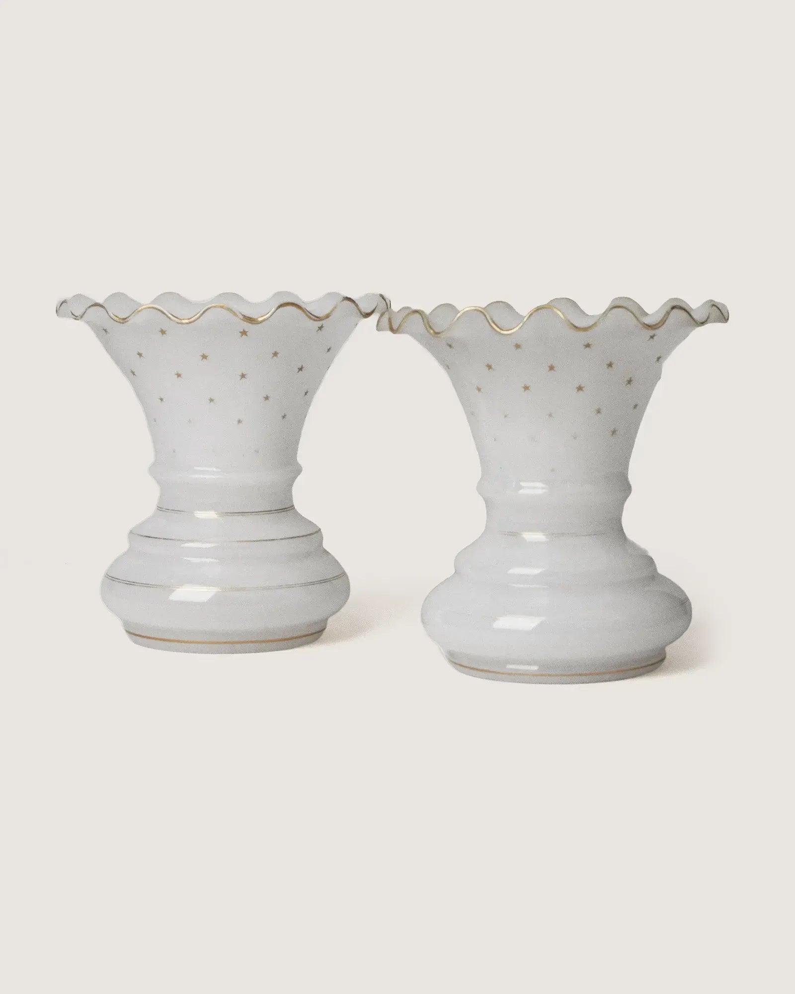 Stunning pair of late 19th-century French white opaline glass vases adorned with delicate gilded gold stars.