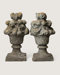 Pair of late 19th or early 20th-century stone and concrete gate trophies depicting heavily detailed baskets of fruit.