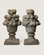 Pair of late 19th or early 20th-century stone and concrete gate trophies depicting heavily detailed baskets of fruit.