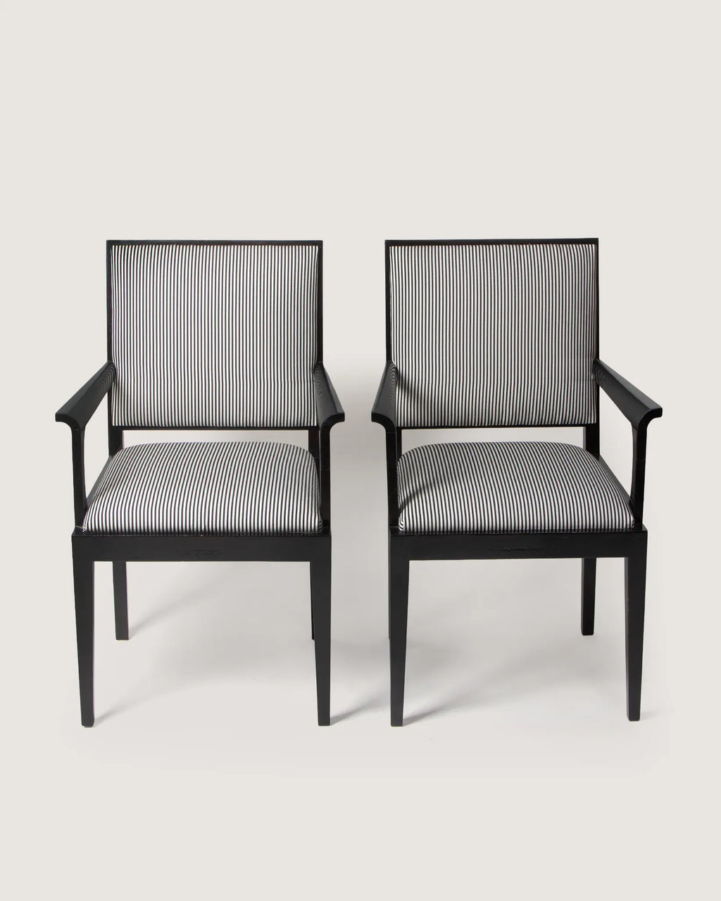 Pair of 1930s Art Deco black lacquered armchairs, bespoke reupholstered in a graphic black and white striped textile.