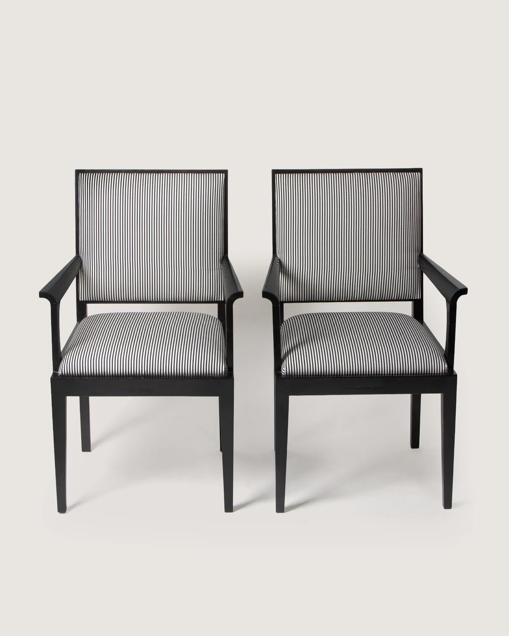 Pair of 1930s Art Deco black lacquered armchairs, bespoke reupholstered in a graphic black and white striped textile.
