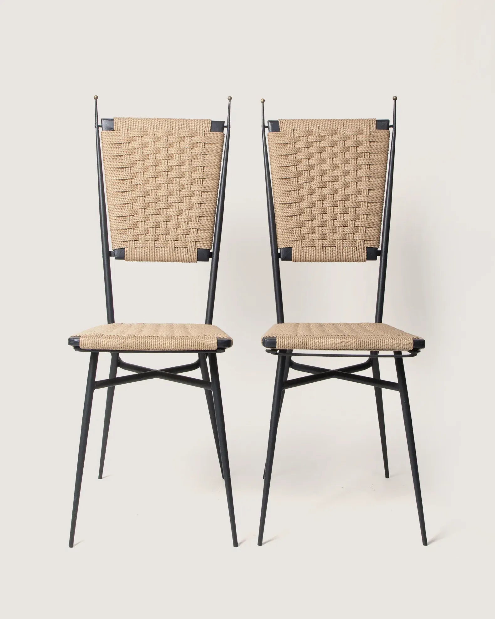 Pair of 1950s mid-century iron garden or accent chairs featuring newly hand-woven natural rope seats and backs.