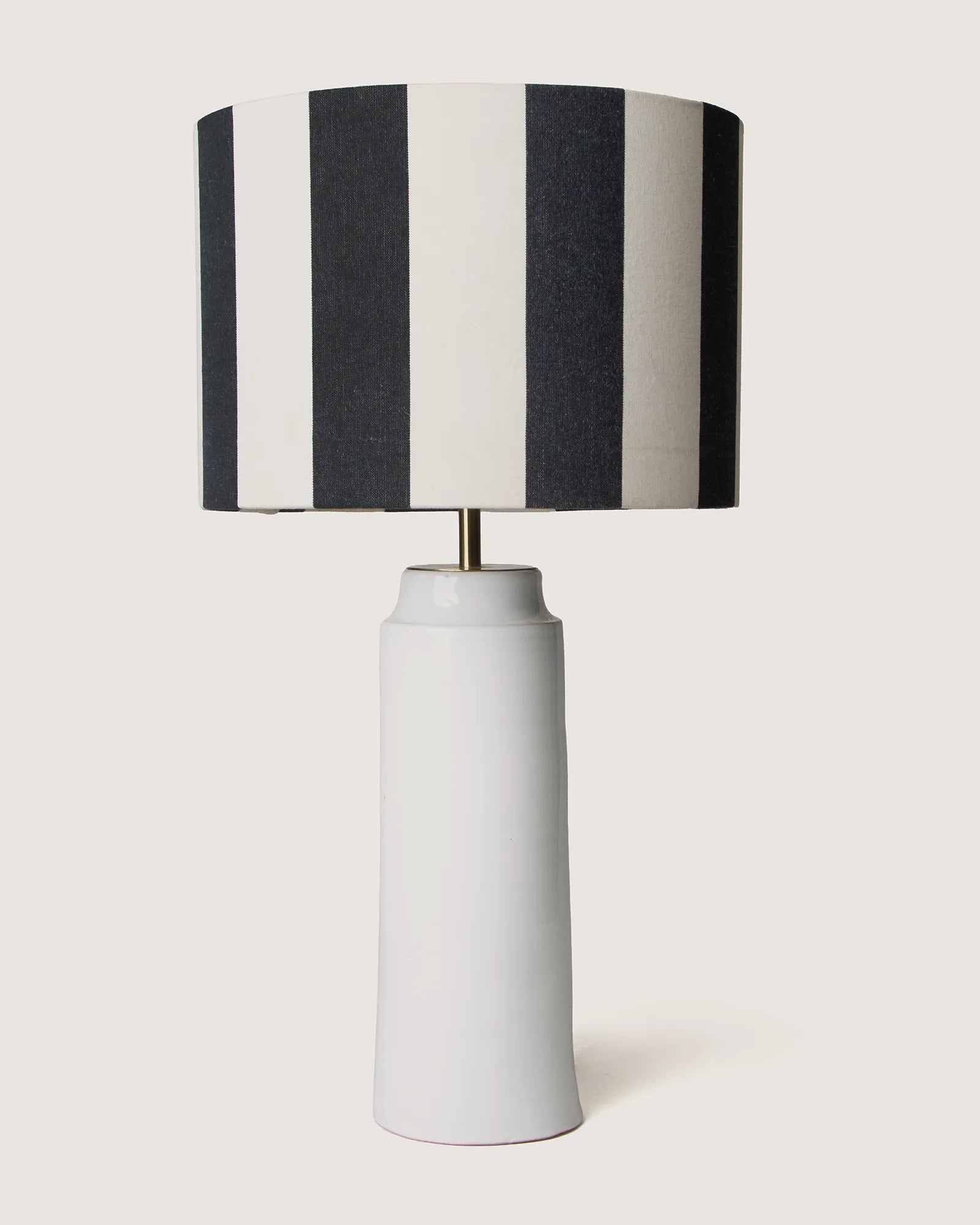 Pair of bespoke white glazed Apulian ceramic table lamps paired with graphic black and white striped shades.