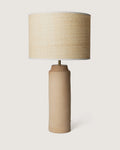 Wabi-sabi style raw Apulian terracotta table lamp featuring a handcrafted organic natural fiber lampshade.