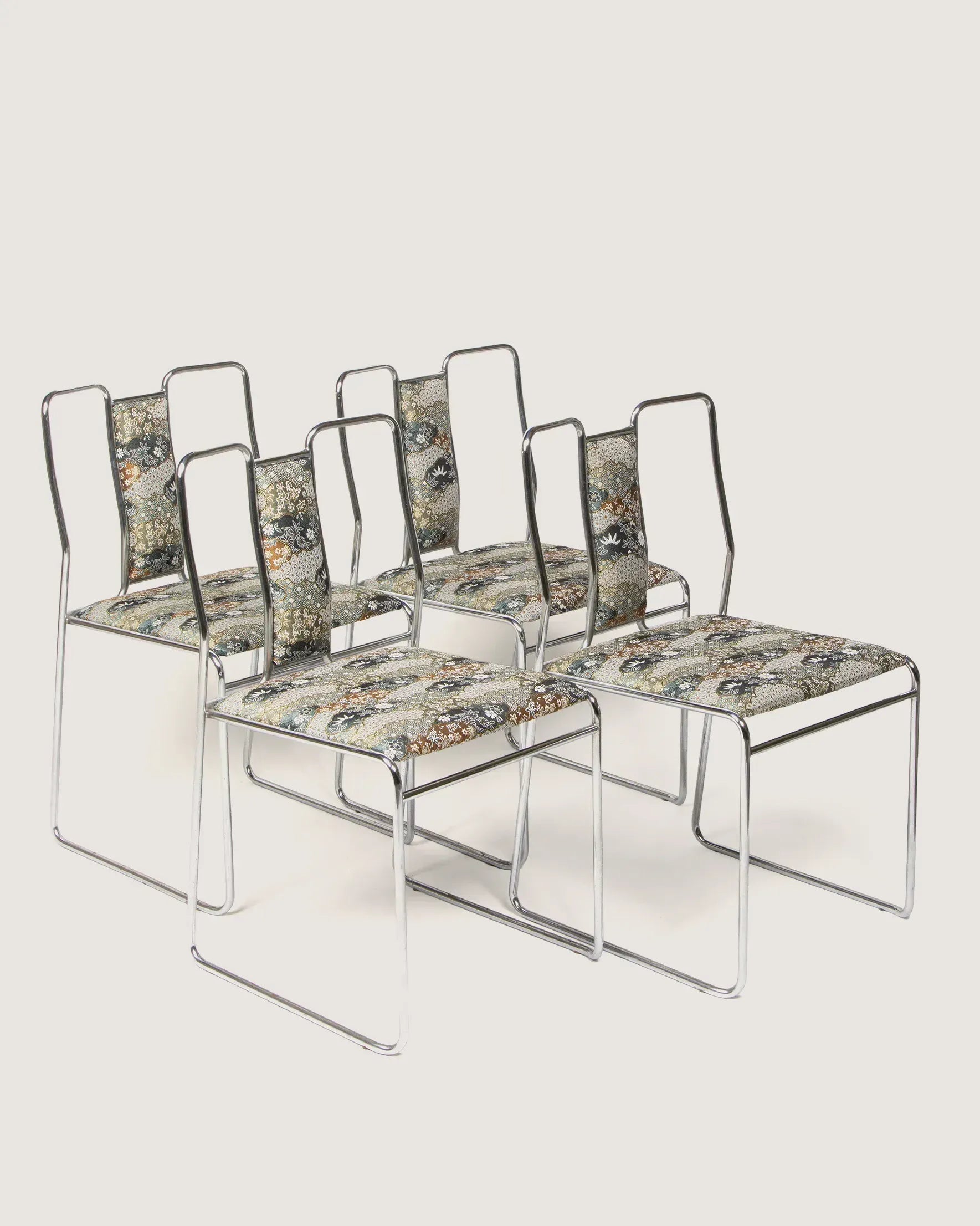 Set of four 1970s mid-century modern chromed tubular steel dining chairs upholstered in a rich patterned Oriental fabric.