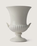 Full front view of the monochrome white Wedgwood glazed vase, highlighting its trumpet silhouette and matching side shell handles.